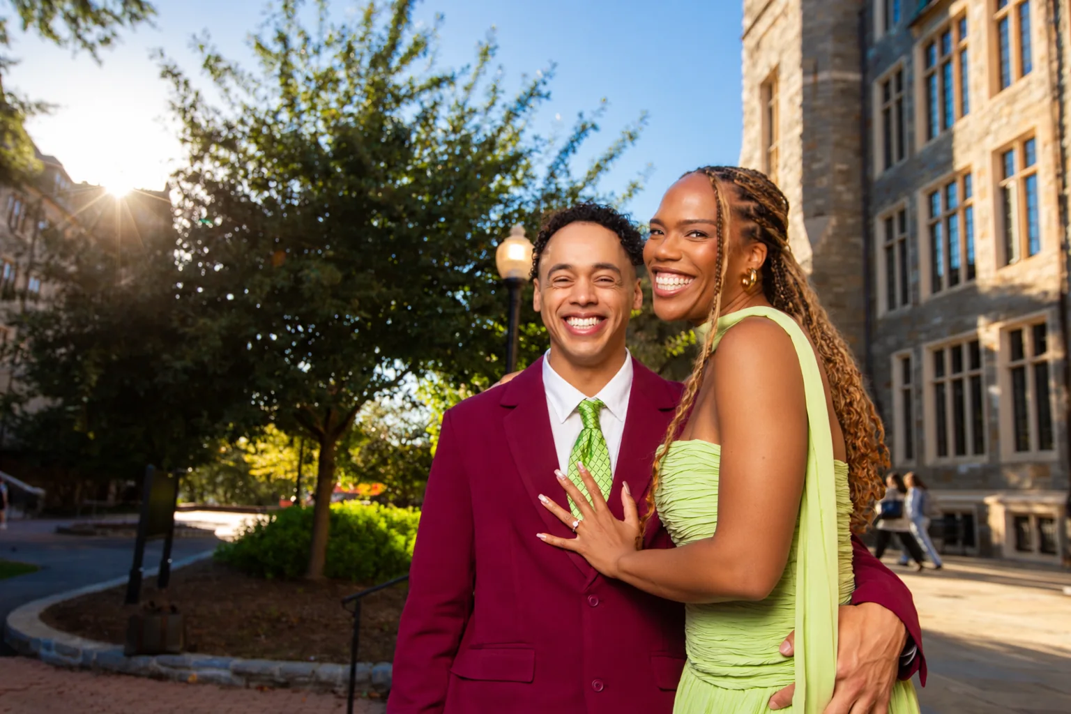 Alexis and Gary smiling together outside in the golden-hour sunshine