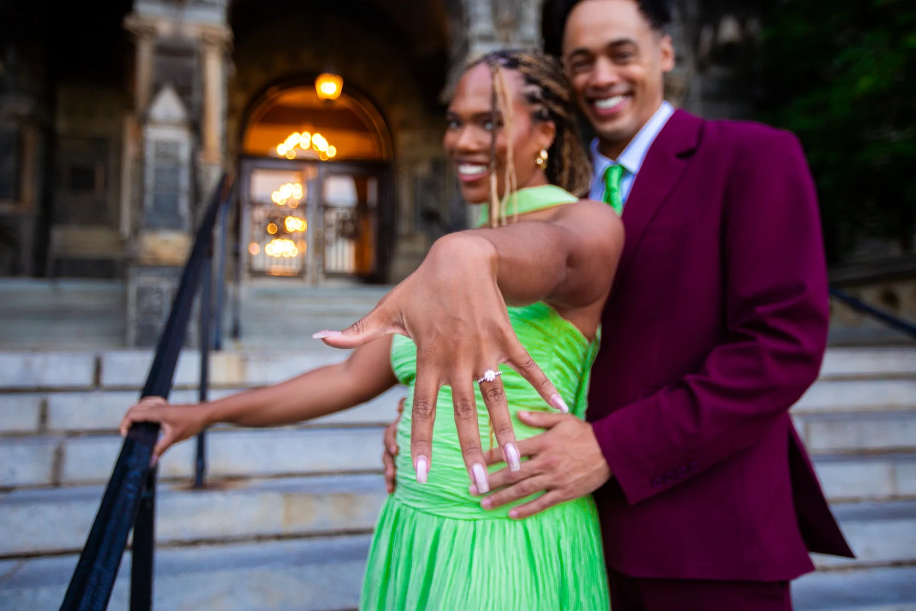 Alexis shows off her ring beside Gary outside the historic building